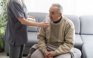 nurse giving man an oxygen mask